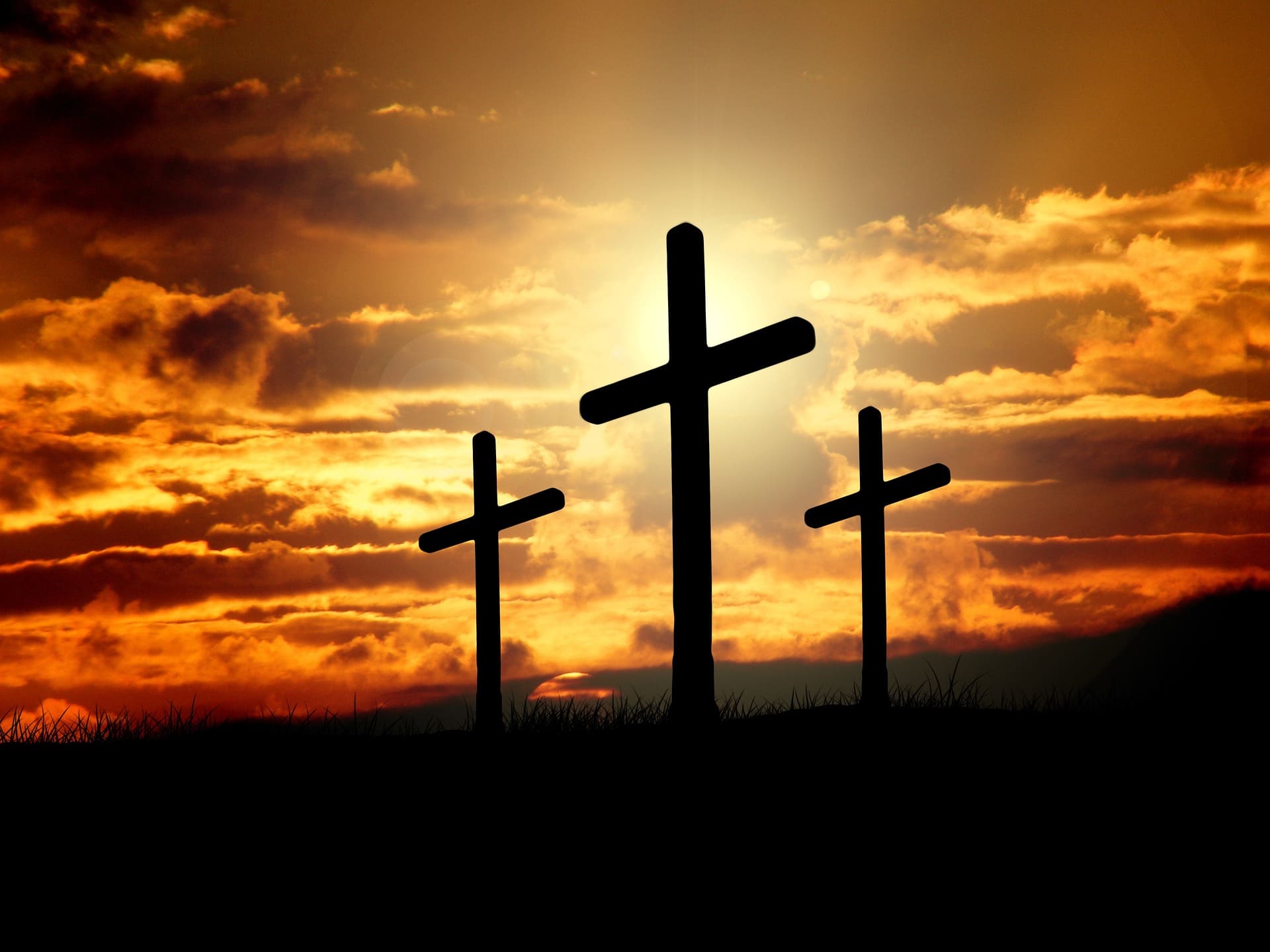 3 crosses silhouetted at sunset